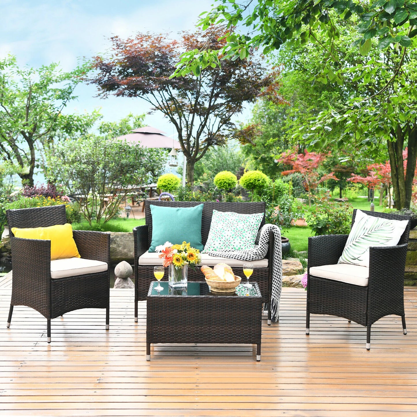 4-Piece Rattan Patio Furniture Set with Cushioned Sofa Chairs & Glass Coffee Table